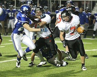 FOOTBALL - (7) Mike Ross tries to get around the end as (27) Ben Angelo blocks (27)Anthony Kosec Friday night in Poland. - Special to The Vindicator/Nick Mays