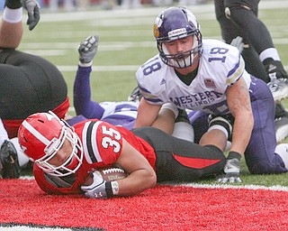 ROBERT K. YOSAY | THE VINDICATOR...YSU  #35  Jamaine Cook dives into the endzone as WIU  #18 Tim Franken can only look on - as YSU vs Western Illinois - homecoming at YSU and a win 56-14 ......-30