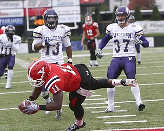 ROBERT K. YOSAY | THE VINDICATOR...#11 Kevin Watts pulls in a Kurt Hess 17 yard pass and dives into the endzone as WIU  #13 Jonathon Rollins  and #37 Ethan Bachinski looks on  YSU vs Western Illinois - homecoming at YSU and a win 56-14 ......-30