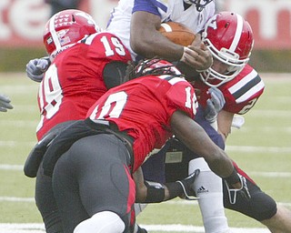 ROBERT K. YOSAY | THE VINDICATOR...No where to go as #20 Larry Patterson WIU  is surrounded byYSU -   19 Daniel Stewart - 10 Josh Lee and   24 Scott Sentner -- YSU vs Western Illinois - homecoming at YSU and a win 56-14 ......-30