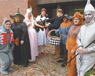 Proponents of pet adoption staged a Halloween event Monday, dressed as the cast of “The Wizard of Oz,” looking for a missing Toto. They found him at the Mahoning County Dog Pound. Participants were, from left, Nicole Ramson of Packer Thomas as a flying monkey, Carol Bukovac of Animal Charity as the Wicked Witch of the West, Diane Less of Angels for Animals as Glinda the Good Witch, Gary Pilcher of Animal Charity as Dorothy, Mahoning County Dog Warden Matt Ditchey, Tyneisha Phillips as the Scarecrow, Kate McDermott of Angels as the Cowardly Lion and Christine Popovich of the Daily Legal News as the Tin Man.