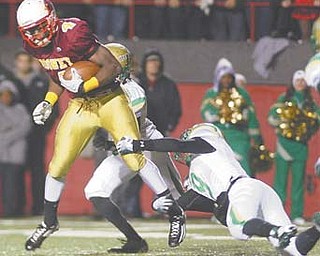 Cardinal Mooney’s Marcus McWilson (4) tries to elude two tackles during the Cardinals’ game against Ursuline on Oct. 21. Mooney will play host to Northwest in a Division III playoff game on Friday.