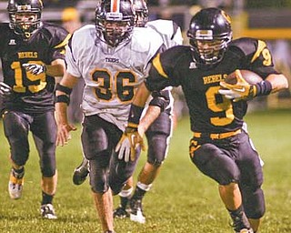 Crestview’s Collin Gilbert (9) races for a big gain during the Rebels’ game against the Springfield Tigers at Crestview Stadium. The Rebels square off tonight against Cuyahoga Heights in the Division V playoff s — a matchup in which both teams combined have 25 playoff appearances.