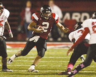 Girard quarterback Dan Graziano (2) runs the ball against the Campbell Memorial defense. The Indians are headed to the Division IV playoff s Saturday against Cleveland Central Catholic, a contest that pits Girard’s strong offense against the Ironmen’s strong defense.