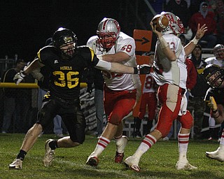 FOOTBALL - (36) of Crestview tries to sack (13) Alex Zander as (58) Austin Lane tries to make a block during thier game Friday night in Crestview. - Special to The Vindicator/Nick Mays