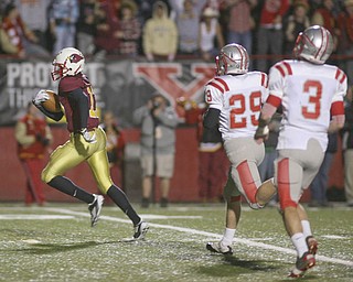 ROBERT K. YOSAY | THE VINDICATOR --..Mooneys #17 Quincy Jones leaves Canal Fultons #29 Mason Tesch and #3 Mike Pribonic in the dust as he scampers for a touchdown during first quarter action ..Cardinal Mooney Cardinals vs Canal Fulton Northwest Indians at Stambaugh Stadium in the Regional Quarterfinals .--30-..(AP Photo/The Vindicator, Robert K. Yosay)