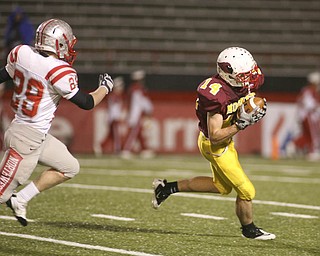 ROBERT K. YOSAY | THE VINDICATOR --..Mooneys #14 Ryan Farragher pulls in a pass and takes it down to the four yardline as as Canal Fultons #29 Mason Tesch can only watch..Cardinal Mooney Cardinals vs Canal Fulton Northwest Indians at Stambaugh Stadium in the Regional Quarterfinals .--30-..(AP Photo/The Vindicator, Robert K. Yosay)