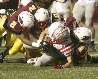 ROBERT K. YOSAY | THE VINDICATOR --..DOWN - Canal Fultons #32 Ronnie Beers is brought down hard by Mooneys #2 Kareem Ellis -310 Justus Ellis-moore and #38 C J Bias during second Quarter action ..Cardinal Mooney Cardinals vs Canal Fulton Northwest Indians at Stambaugh Stadium in the Regional Quarterfinals .--30-..(AP Photo/The Vindicator, Robert K. Yosay)