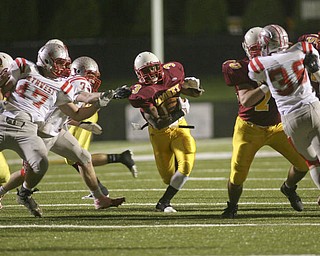 ROBERT K. YOSAY | THE VINDICATOR --..Big Whole #3 Mooneys Roosevelt Griffin takes off for a first and ten as his teamates open a big whole during first half action..Cardinal Mooney Cardinals vs Canal Fulton Northwest Indians at Stambaugh Stadium in the Regional Quarterfinals .--30-..(AP Photo/The Vindicator, Robert K. Yosay)