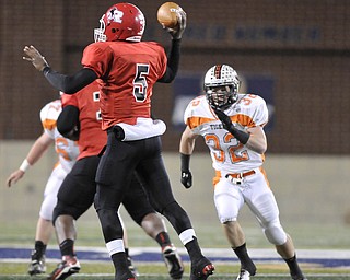 Howland linebacker #32 Daniel Russell puts pressure on Roosevelt quarterback #5 Brendan Cope.