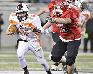 Howland quarterback #19 Eric Lockney scrambles away from Roosevelt defensivelinemen #75Austin Mastroine.