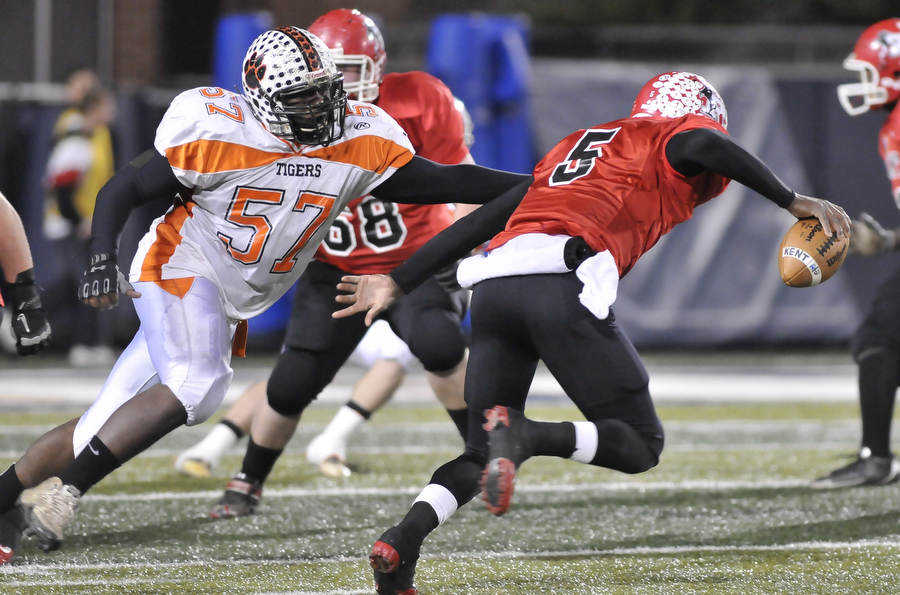 Howland defensive linemen #57 Jayson Freeman puts pressure on Kent Roosevelt #5 TraVon Chapman.