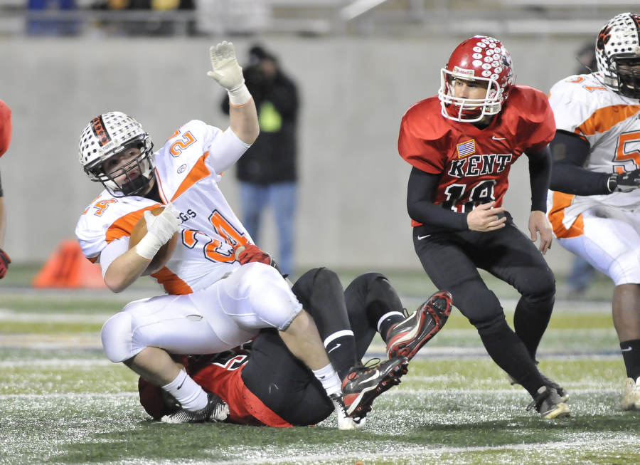 Howland receiver #24 Tyler Drass is tackled by Roosevelt's #51 Robert Hayden.