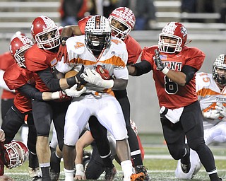 Howland running back #4 DeVeon Smith is tackled by a pack of Kent Roosevelt Roughriders.