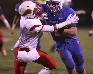 ROBERT K. YOSAY | THE VINDICATOR --..Western Reserves #2 Donnie Bolton pushes The vikings C. J. Germany out of the way as he goes for a fist down at the..Regional quarter final at Western Reserve Stadium - Western Reserve Blue Devils VS Villa Angela St Joesph Vikings.--30-..(AP Photo/The Vindicator, Robert K. Yosay)