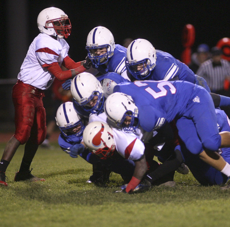 ROBERT  K.  YOSAY  | THE VINDICATOR --..big Sack led by #57 Sam Steininger  and a host of blue devils as they smother  Anthony Sywanyk the Vikings qb for a big loss..Regional quarter final at Western Reserve Stadium - Western Reserve Blue Devils  VS   Villa Angela St Joesph Vikings.--30-..(AP Photo/The Vindicator, Robert K. Yosay)