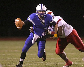 ROBERT K. YOSAY | THE VINDICATOR --..Jeff Clegg QB under heavy pressure by Adam Scott as he looks downfield for his receivers -during first quarter action..Regional quarter final at Western Reserve Stadium - Western Reserve Blue Devils VS Villa Angela St Joesph Vikings.--30-..(AP Photo/The Vindicator, Robert K. Yosay)