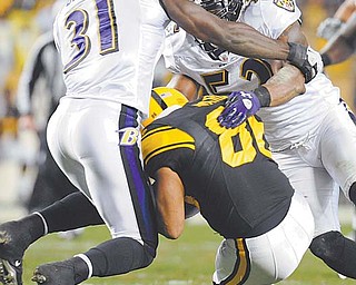 Baltimore Ravens safety Bernard Pollard (31) and LB Ray Lewis (52) hit Pittsburgh Steelers wide receiver
Hines Ward after he made a catch in the second quarter of Sunday’s NFL game in Pittsburgh. Ward was
injured and helped from the fi eld. The Steelers rallied but came up short against the Ravens, losing 23-20.