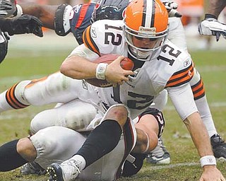 Cleveland Browns quarterback Colt McCoy (12) is sacked by a Houston Texans defenders in the third quarter of Sunday’s NFL game at Reliant Stadium in Houston. The Browns lost 30-12, with McCoy playing the role of pinata in his fi rst NFL game in his home state, getting sacked four times and unoffi cially hit on eight other occasions.