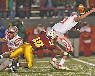 Cardinal Mooney’s Justus Ellis-Moore (10) takes down Northwest quarterback Nick Riley, causing a fumble, during last Friday’s Division III playoff game at Stambaugh Stadium. The Cardinals play Steubenville in a regional semifi nal on Friday night.