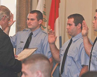 Youngstown Police Chief Rod Foley, left, welcomed six new offi cers to the department after a
swearing-in ceremony at city hall. They are, from left, Nick Bailey, Eric Ruschak, Michael Medvec,
Nick Menichini, Jose Morales and Jimmy Hughes Jr.