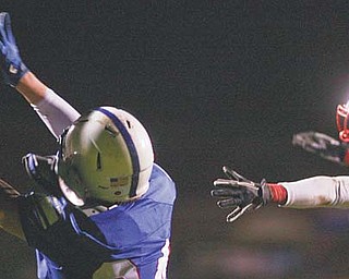 Western Reserve’s Thomas Benyo hauls in this pass while Villa Angela-St. Joseph’s Mato Vunak chases during their playoff game last weekend at Western Reserve High. The top-seeded Blue Devils won 33-6.