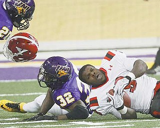 Northern Iowa’s James Conley, center, pops off Youngstown State’s Adaris Bellamy’s helmet in the first half of Saturday’s game. Penguins coach Eric Wolford wants to see his team run as well in the fourth quarter as it does in the other three.