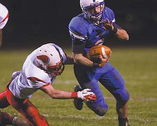 Western Reserve’s Tim Cooper escapes a tackle attempt by Villa Angela-St. Joseph’s Ryan Gallagher in the Blue Devils’ playoff win. Saturday, Western Reserve will take on Malvern in Louisville.