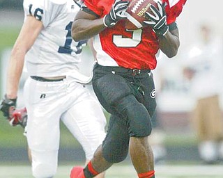 Girard’s Branden Byrd heads for the end zone after hauling in a pass from quarterback Dan Graziano during a regular-season game against Warren JFK. Byrd says the Indians defense has discovered a simple way to stop the opposition from scoring: “If you wrap them up, they’ll go down.”