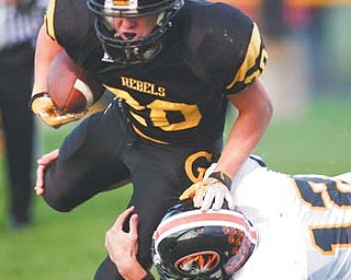 Crestview’s Kris Simpson (20) is tackled short of a touchdown after catching a pass from quarterback Adam Coppock in a regular-season game against the Springfield Tigers. After a 40-37 loss to start the season, the Rebels went on a 10-game win streak and into the playoffs.