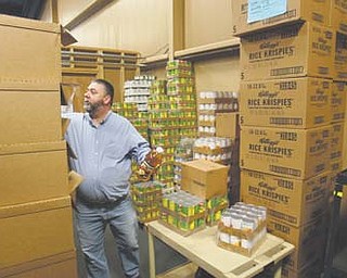 Pastor Joseph Delapa of High Pointe Church in Lowellville sorts through supplies for the free Thanksgiving dinner the church will sponsor Nov. 17 at Struthers High School. It’s the 14th such event for the Assembly of God congregation and is among a host of such dinners in the Valley.