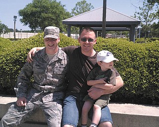 In May, these two Newton Falls brothers met at Norfolk Naval Station in Virginia prior to their deployments. Dustin Sickle, left, is stationed at Little Rock Air Force Base in Arkansas and flew into this older brother Shawn Eaken's (right) home port before his deployment. Just four days later, Shawn was deployed for the third time aboard the USS Anzio. Dustin has been in the Air Force for over two years as a communication and navigation avionics technician. Shawn has been in the Navy for 10 years as an electronics technician. He is married to the former Elena Cook, also of Newton Falls, and is pictured holding his 4-year-old son, Zachary.