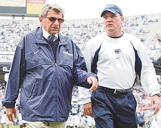 Penn State coach Joe Paterno walks onto the field with assistant coach Tom Bradley before a game against Syracuse. Penn State trustees chose Bradley as interim head coach for the remainder of the season in the wake of Wednesday’s firing of Paterno and university president Graham Spanier amid the growing furor over how they handled sex abuse allegations against a retired assistant coach.