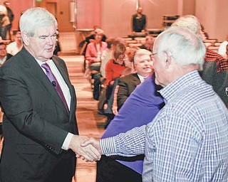 Republican presidential hopeful former House Speaker Newt Gingrich shakes hands with an audience member while campaigning at the Westin Hotel at Detroit Metro Airport in Romulus, Mich., on Thursday.