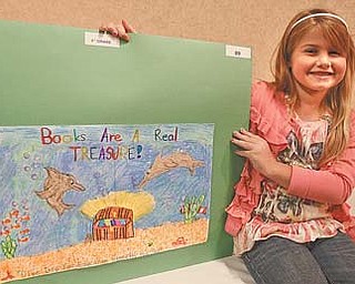 Hilltop Elementary School student Briana Maurer proudly displays the poster she created for the Mahoning County Juvenile Court Advisory Board’s eighth annual school poster contest. Briana won second place in the third-grade county category.