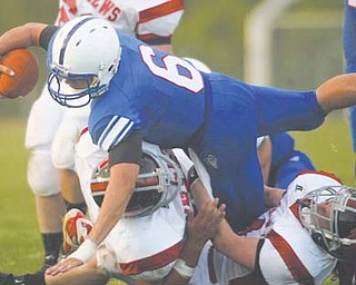 Western Reserve QB Jeff Clegg (6) dives for extra yardage over Mathews’ defenders. Tonight’s Division VI regional semifinal between the Blue Devils and the Malvern Hornets features two teams with an potent offense, solid runners and a scrappy line.