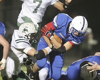 ROBERT K. YOSAY | THE VINDICATOR --..Donnie Bolton for Western Reserve drives thru the line for a first down as #52 Logan Sellers and #7 Shawn Ball for Malvern attempt to stop him during first quarter action in Louisville..Regional quarter final at Western Reserve Stadium - Western Reserve Blue Devils VS Malvern Hornets at Louisville.--30-..(AP Photo/The Vindicator, Robert K. Yosay)