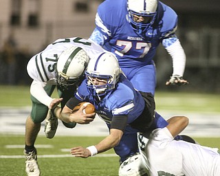 ROBERT K. YOSAY | THE VINDICATOR --..Jeff Clegg is stopped after getting afirst down in the first drive in the third quarter by #7 Shawn Ball and 75 Tyler Litten - behind them #77 Aaron Halls - ..Regional quarter final at Western Reserve Stadium - Western Reserve Blue Devils VS Malvern Hornets at Louisville.--30-..(AP Photo/The Vindicator, Robert K. Yosay)