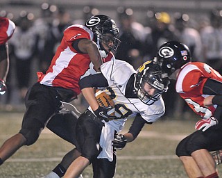 Black River running back Zach Marror #28 is tackled by Girard defenders #8 (name not on roster) and #33 James Cupan.