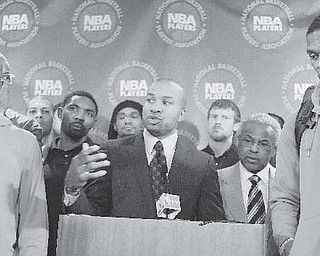 Surrounded by NBA players, including New York Knicks’ Chauncy Billups, left, and Oklahoma City Thunder’s Russell Westbrook, right, NBA Players Association president Derek Fisher speaks during a news conference after a meeting of the players’ union in New York Monday.