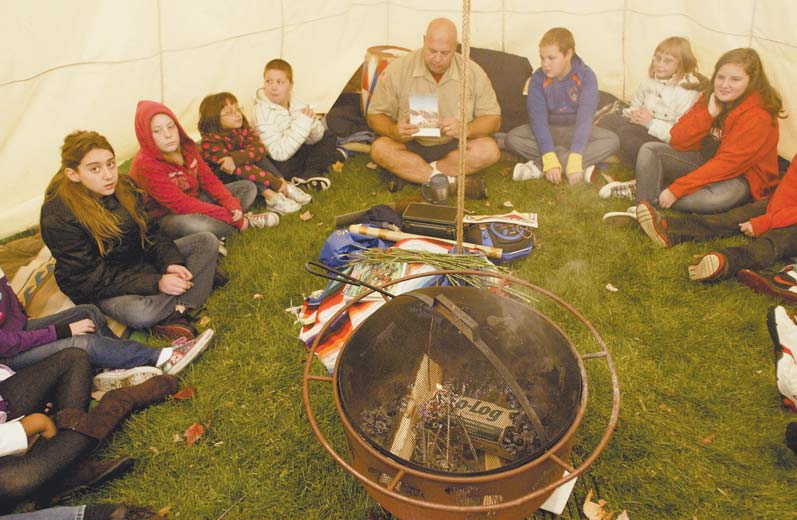 Wes Jones, owner of Native Life Tipi Rental, set up camp on the lawn of Struthers Elementary School. He began teaching classes in Native American culture Monday and will continue to do so through Thursday.