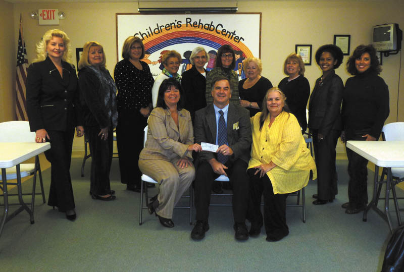 'Tutor U' gets a boost. Members of the Trumbull County Women's History Celebration Committee recently presented a $500 check to Executive Director Robert C. Foster of the Children's Rehabilitation Center for its "Tutor U" program. The program is designed to assist third-grade through eighth-grade youngsters who need extra academic help. Tutor U is offered from 4 to 7:30 p.m. Monday through Friday at the center, 885 Howland-Wilson Road NE, Howland. Call 330-856-2107, ext. 106, to set up a tutoring appointment. Standing, from left to right, are Julie Vugrinovich, Esther Gartland, Beky Davis, Theresa Salcone, Roz Jackson, Pam Hallett, Judie Hartley, Jo Anne Liptak, Kenya Howard and Stephanie Furano. Seated are Renee Maiorca, Foster and E. Carol Maxwell.