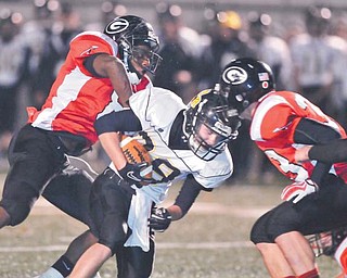 Black River running back Zach Marror (28) is tackled by a Girard defender as James Cupan (33) of the Indians comes in to help. Girard plays Norwayne on Saturday night in the Division IV, Region 13 championship game.



