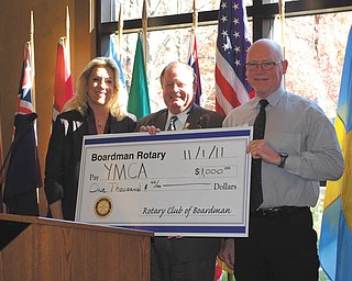 Boardman Rotary member Ted Thornton, center, presents a check to Carol Potter and Mike Schaffer of the YMCA to help fund programs for disadvantaged youths.