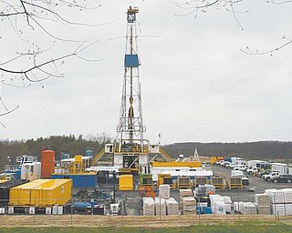 Oil-drilling derricks such as this one, outside Carrollton in Carroll County, could soon start appearing throughout the Mahoning Valley, based on an uptick in signed leases, especially in southeast Mahoning County. The boom in such leases has begun to spread to western townships.