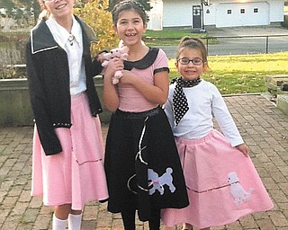 Ready for the record hop: Sisters D'Ella, Mille and Sophie Heschmeyer of Liberty celebrated the 50th day of school when Akiva Academy in Youngstown had a '50s day. The girls donned their best 1950s outfits for the occasion as students and teachers dressed in poodle skirts, rolled up jeans, slicked-back hair and leather jackets. They even listened to music on what the kids described as "weird dishes" — vinyl LPs. The whole elementary school learned about the culture of the 1950s era and enjoyed pizza and root beer floats for lunch.