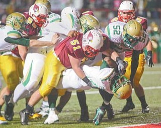 Mooney defender Carmen Lanzo (51) grabs Ursuline’s Jesse Curry during their game in Week 9. Lanzo’s Cardinals will play Chagrin Falls on Friday in a state semifinal.