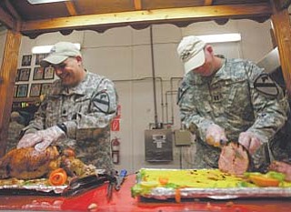 U.S. soldiers serve the last Thanksgiving meal at Contingency Operating Site Echo in Diwaniyah, 80 miles south of Baghdad, Iraq.