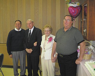 Vada Reel of Austintown recently celebrated her 90th birthday. She was joined Nov. 20 by more than 200 friends at Smith Corners United Methodist Church. Hosting the event were her sons and their wives: Kenneth (Mary Ann), Gary (Sandie) and Wayne (Judi) Reel. Attending the event were her sisters, Freda Kochera of Austintown and Janice (Bob) Wehr of Dallas. Her family includes eight grandchildren and eight great-grandchildren. Mrs. Reel has lived in Austintown most of her life and lives in the house built in 1940, before her marriage, by her late husband, Jack. She is active in Smith Corners Church, serving as the organist and pianist for the past 74 years; the Dublin Grange in Canfield; and the Farm Bureau. From left to right are Gary, Kenneth, Vada and Wayne Reel.