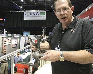 ROBERT K. YOSAY | THE VINDICATOR..From the Plumbers and Steamfitters - Jim Young shows some of the new equipment in use and yet some of the standard plumbing - used in well drilling - from the Plumbers and Steamfitters Union 396 495 "The YOUNG 2011 Conference and Expo Ñ the first Utica shale play conference in the state of Ohio Ñ is a dedicated B2B conference in which national and local companies can exhibit their products and interact with key players in the burgeoning Utica and Marcellus supply chain. at the Covelli Centre .. .-30